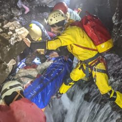 A cave rescue team lifts an injured