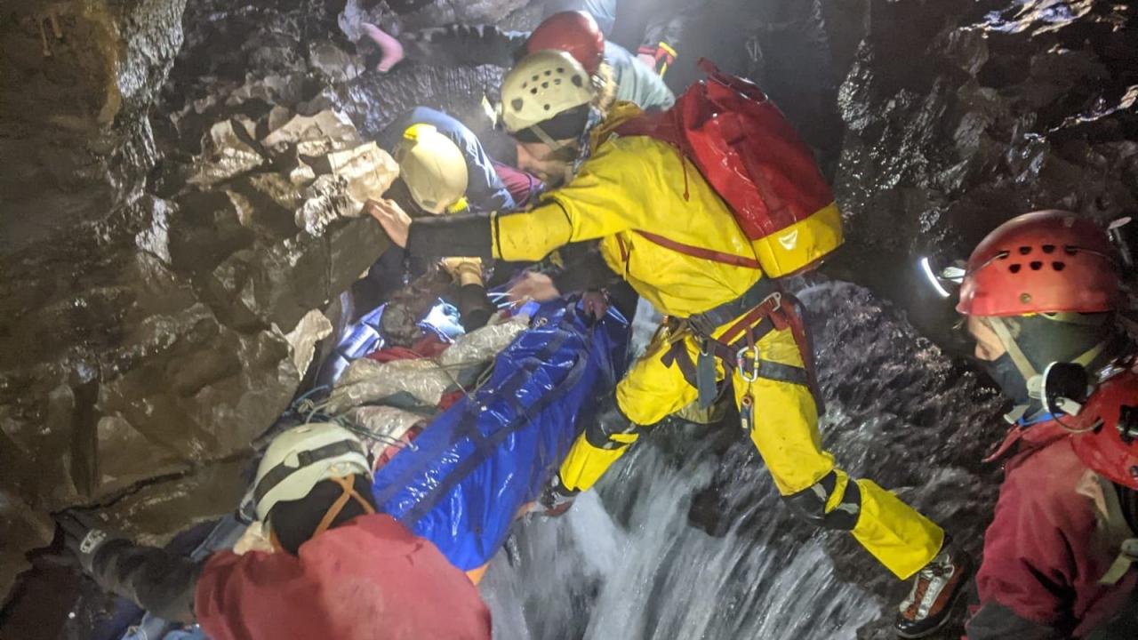 A cave rescue team lifts an injured